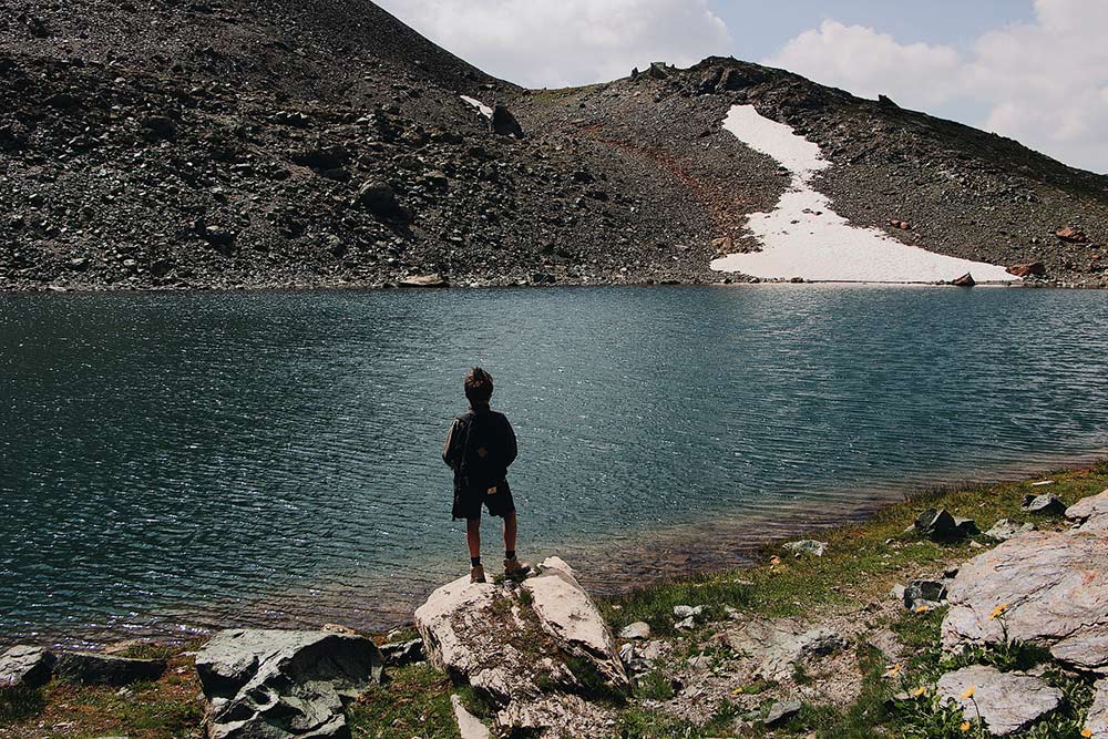 A boy in front of a lake